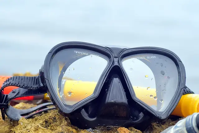 A diving mask on the shore