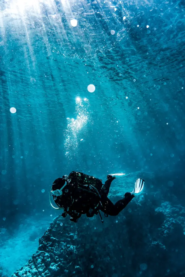 A person in diving gear swimming underwater